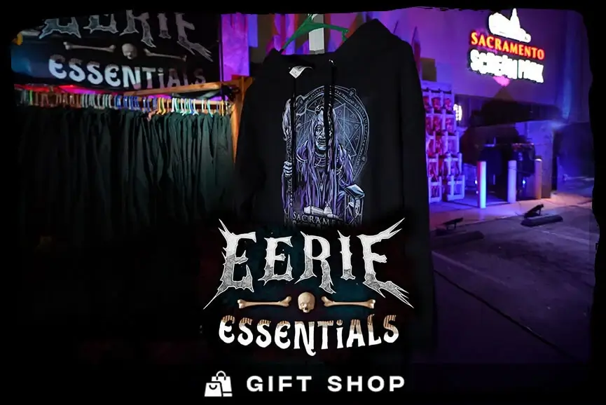 A black hoodie with the Sacramento Scream Park logo hangs at this outdoor gift shop.